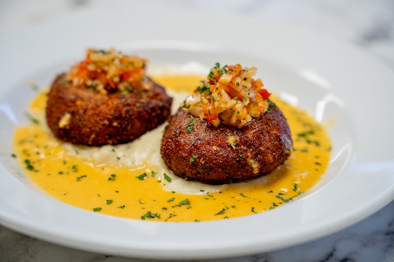 Crab cake entrée with mustard sauce and relish