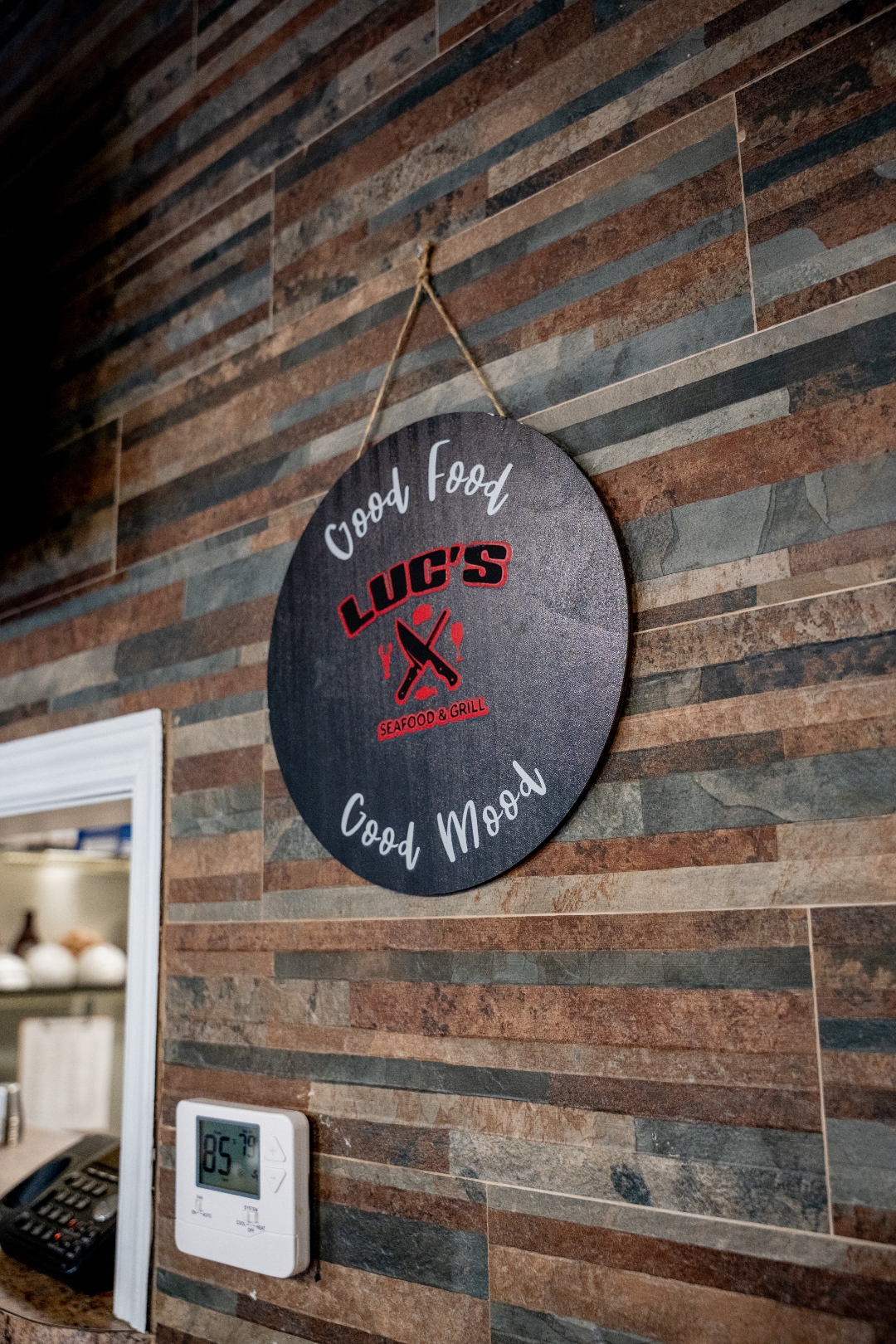 Round wooden Luc's Seafood & Grill Good Food Good Mood wall sign