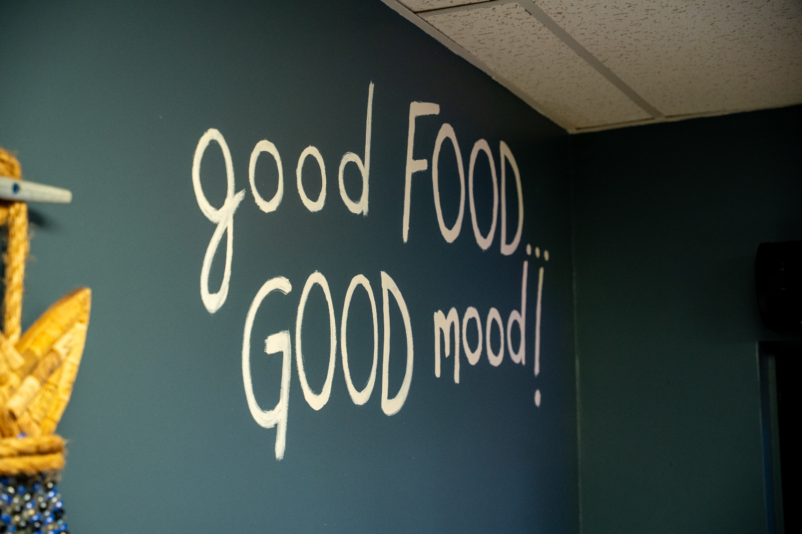 Good Food Good Mood mural on the dining room wall
