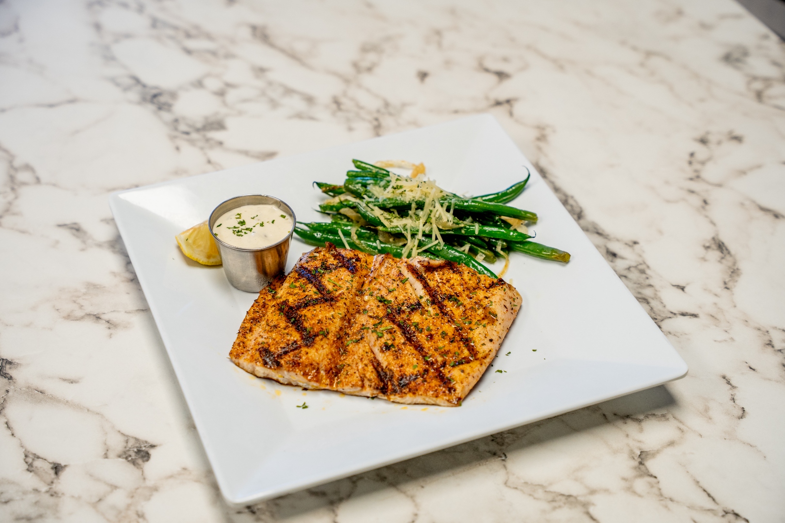 Grilled local fish with green beans and sauce