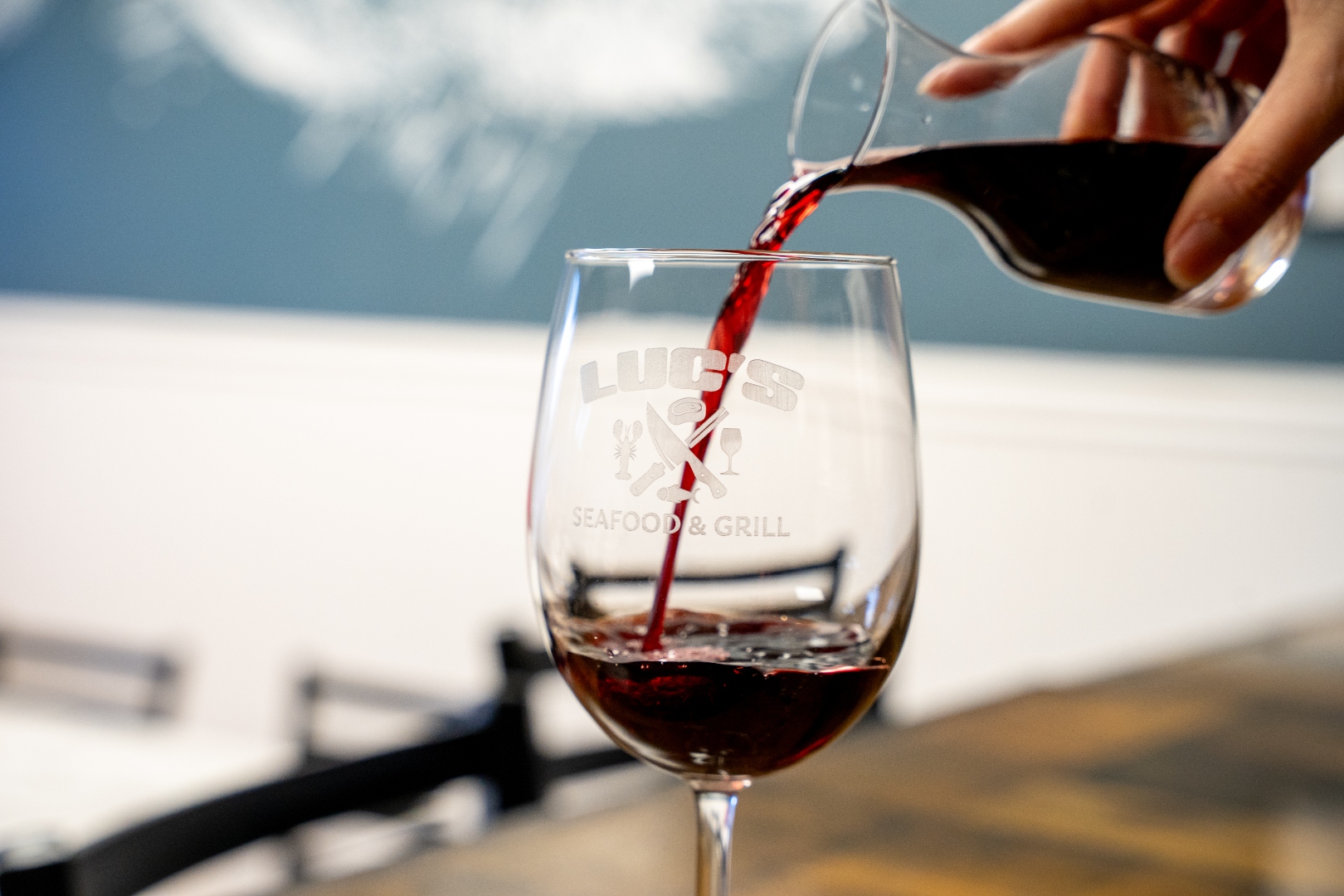 Red wine poured into a Luc's branded glass